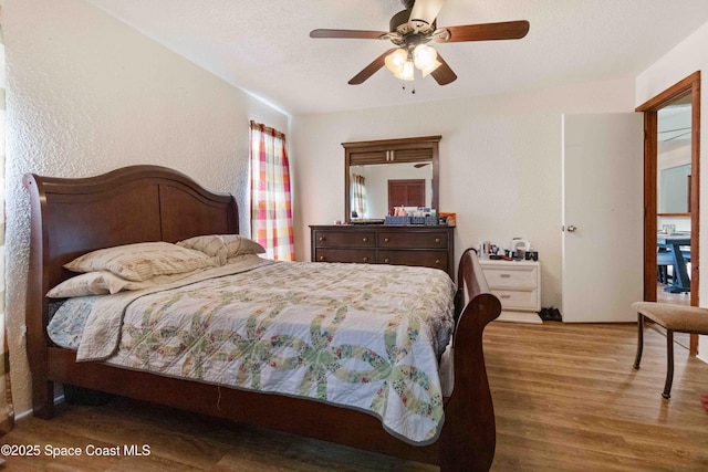 1019 Lee Ave NW, Palm Bay, FL 32907 - bedroom featuring wood finished floors, a textured wall, and a ceiling fan