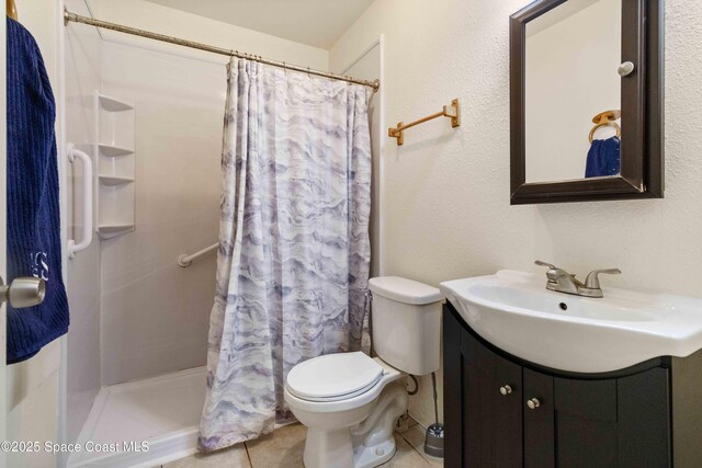 1019 Lee Ave NW, Palm Bay, FL 32907 - bathroom with tile patterned floors, toilet, a stall shower, and vanity