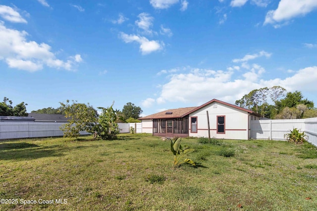 1019 Lee Ave NW, Palm Bay, FL 32907 - view of yard with a fenced backyard and a sunroom