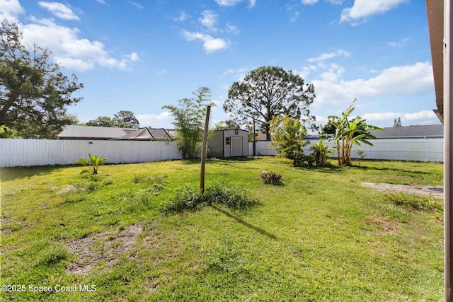 1019 Lee Ave NW, Palm Bay, FL 32907 - view of yard featuring a fenced backyard, an outbuilding, and a storage unit