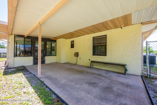 2102 E Parkton Dr, Deltona, FL 32725 - view of patio with central AC unit and an attached carport