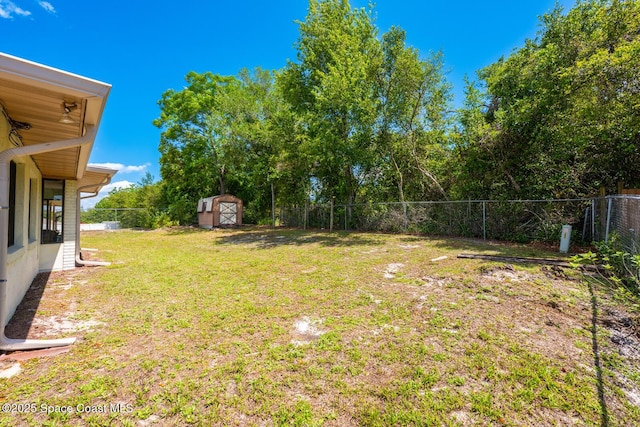 2102 E Parkton Dr, Deltona, FL 32725 - view of yard with a storage unit, a fenced backyard, and an outbuilding