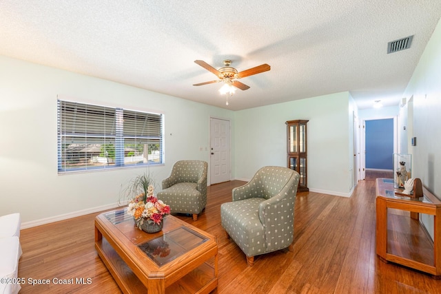 2102 E Parkton Dr, Deltona, FL 32725 - living room with a ceiling fan, visible vents, baseboards, a textured ceiling, and wood finished floors