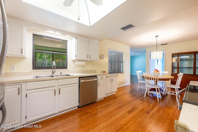 2102 E Parkton Dr, Deltona, FL 32725 - kitchen featuring a sink, visible vents, light wood-style flooring, dishwasher, and white cabinets