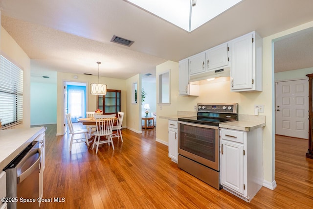 2102 E Parkton Dr, Deltona, FL 32725 - kitchen with stainless steel appliances, under cabinet range hood, visible vents, light countertops, and white cabinets