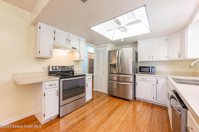 2102 E Parkton Dr, Deltona, FL 32725 - kitchen featuring a sink, under cabinet range hood, light wood-type flooring, a ceiling fan, and appliances with stainless steel finishes