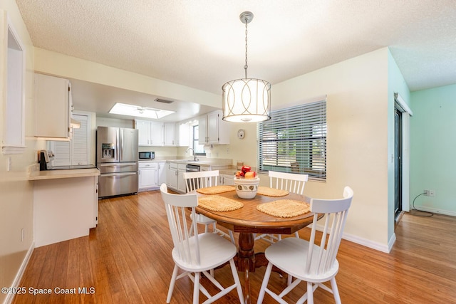 2102 E Parkton Dr, Deltona, FL 32725 - dining area with visible vents, baseboards, and light wood-type flooring