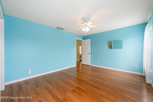 2102 E Parkton Dr, Deltona, FL 32725 - unfurnished room with a textured ceiling, visible vents, baseboards, wood finished floors, and a ceiling fan