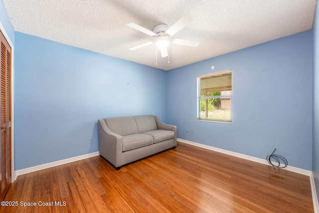 2102 E Parkton Dr, Deltona, FL 32725 - unfurnished room with baseboards, wood finished floors, ceiling fan, and a textured ceiling