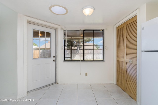 2062 Bottlebrush Dr, Melbourne, FL 32935 - doorway to outside with baseboards and light tile patterned flooring