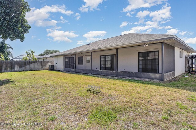 2062 Bottlebrush Dr, Melbourne, FL 32935 - rear view of property featuring a yard, fence, cooling unit, stucco siding, and roof with shingles