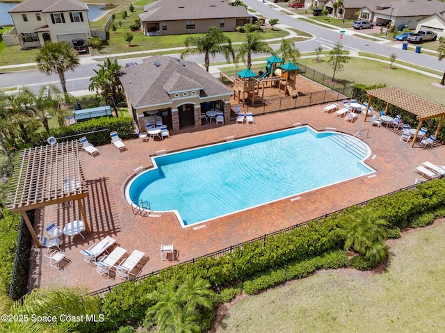 830 Remington Green Dr SE, Palm Bay, FL 32909 - community pool featuring fence, a patio, a residential view, and playground community