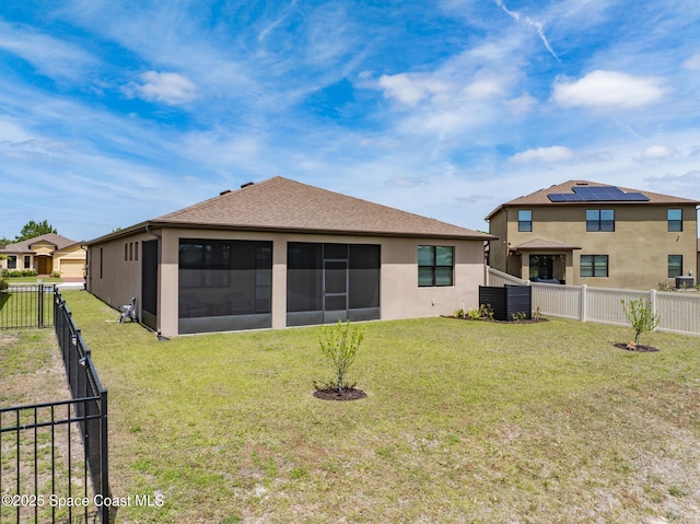 830 Remington Green Dr SE, Palm Bay, FL 32909 - back of property featuring a lawn, a fenced backyard, stucco siding, and a sunroom