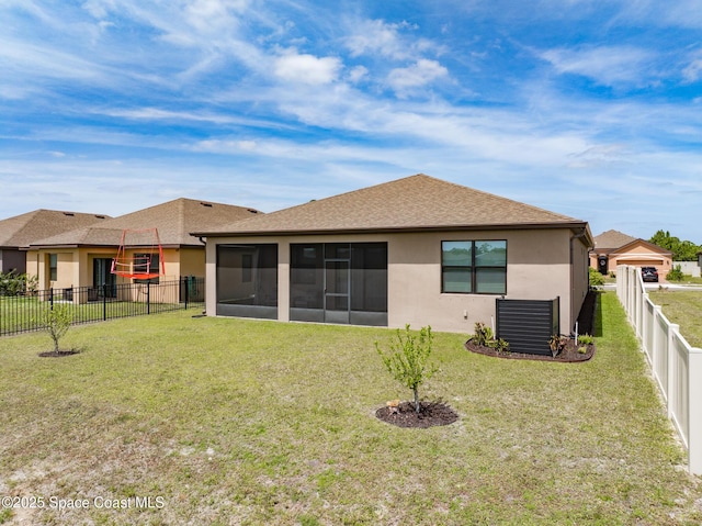 830 Remington Green Dr SE, Palm Bay, FL 32909 - back of property with a shingled roof, stucco siding, a sunroom, a fenced backyard, and a lawn