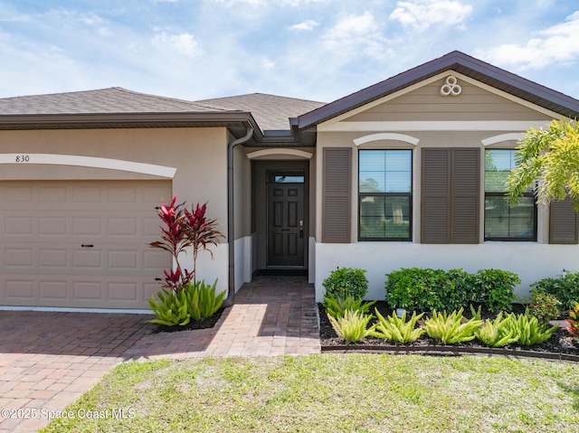 830 Remington Green Dr SE, Palm Bay, FL 32909 - view of front of home with an attached garage, stucco siding, and driveway