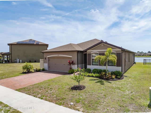 830 Remington Green Dr SE, Palm Bay, FL 32909 - ranch-style house featuring an attached garage, decorative driveway, stucco siding, and a front yard