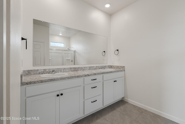 830 Remington Green Dr SE, Palm Bay, FL 32909 - full bathroom featuring a sink, double vanity, tile patterned floors, baseboards, and a shower stall