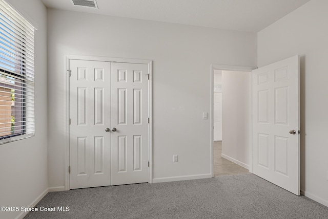 830 Remington Green Dr SE, Palm Bay, FL 32909 - unfurnished bedroom featuring visible vents, baseboards, multiple windows, and light carpet