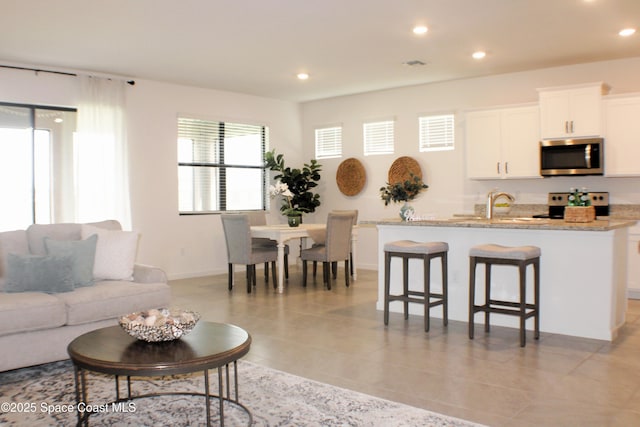 830 Remington Green Dr SE, Palm Bay, FL 32909 - living area with recessed lighting, baseboards, and visible vents