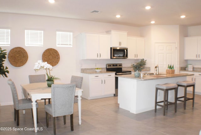 830 Remington Green Dr SE, Palm Bay, FL 32909 - kitchen with a sink, appliances with stainless steel finishes, white cabinets, and recessed lighting