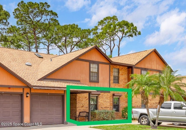 9025 York Ln Unit 11B, West Melbourne, FL 32904 - view of front of house with brick siding, an attached garage, roof with shingles, and driveway
