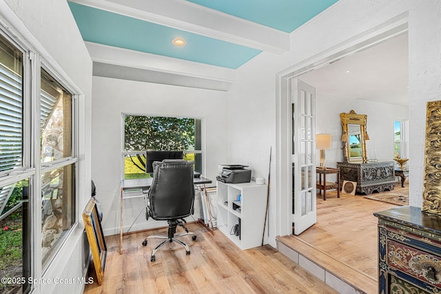 office featuring light wood-style floors, french doors, and beam ceiling