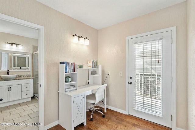 100 Woods S Dr, Merritt Island, FL 32952 - home office with a sink, baseboards, and light wood-style floors