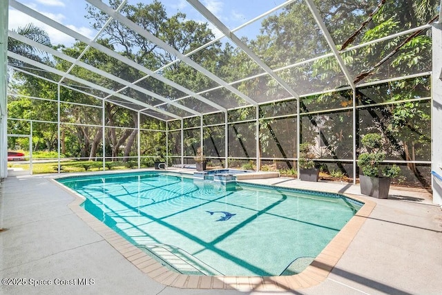 100 Woods S Dr, Merritt Island, FL 32952 - view of pool featuring glass enclosure, a pool with connected hot tub, and a patio area