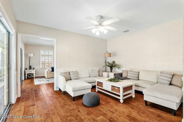 100 Woods S Dr, Merritt Island, FL 32952 - living room featuring ceiling fan, visible vents, and wood finished floors