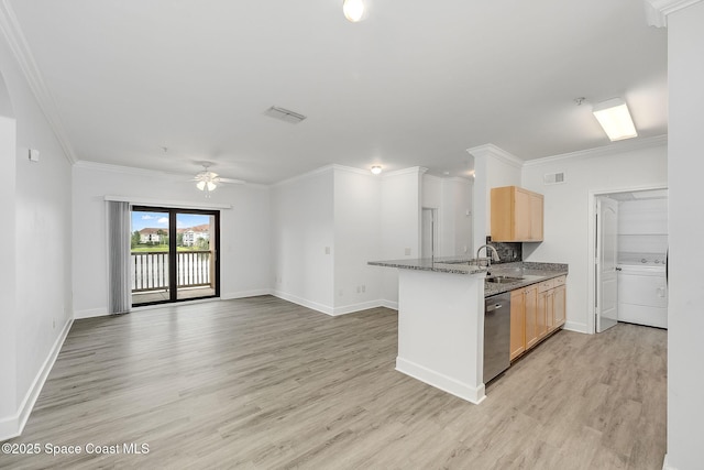 kitchen featuring washer / clothes dryer, stainless steel dishwasher, light wood finished floors, and light brown cabinets