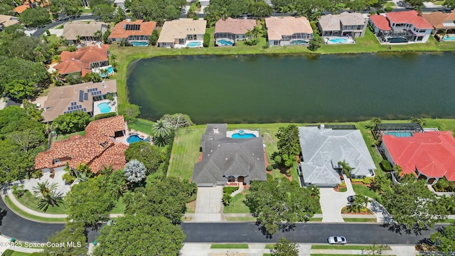 aerial perspective of suburban area featuring a large body of water and a pool