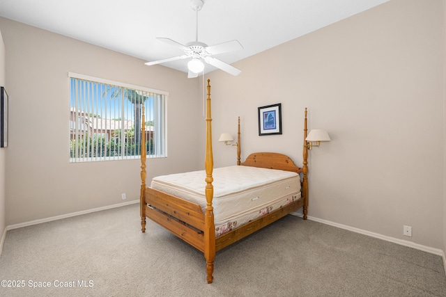 bedroom featuring light carpet, baseboards, and a ceiling fan
