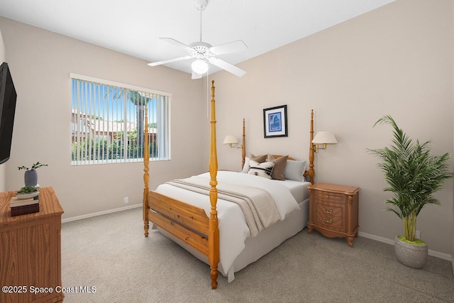 bedroom featuring light colored carpet, baseboards, and ceiling fan