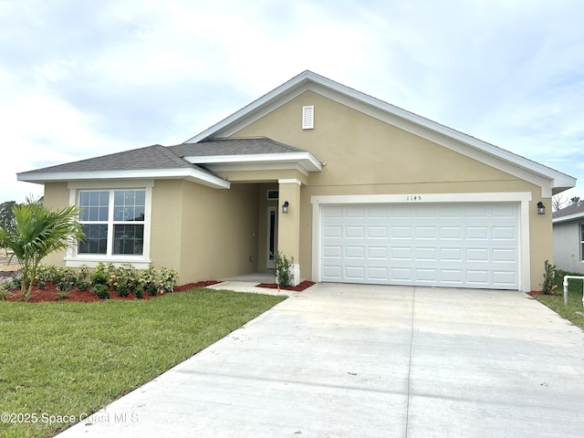 1145 Kylar Dr NW, Palm Bay, FL 32907 - view of front of property featuring stucco siding, concrete driveway, a garage, a front lawn, and a shingled roof