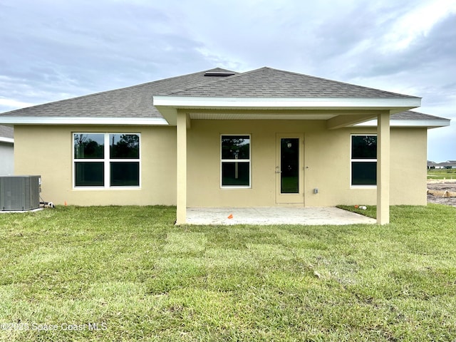 1145 Kylar Dr NW, Palm Bay, FL 32907 - back of house with a shingled roof, a patio, stucco siding, and a yard