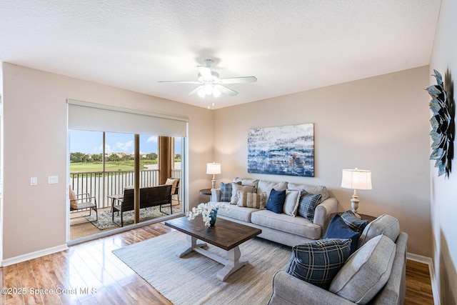 6838 Toland Dr Unit 307, Melbourne, FL 32940 - living room with baseboards, light wood-style flooring, and a ceiling fan