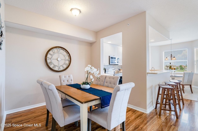 6838 Toland Dr Unit 307, Melbourne, FL 32940 - dining space with light wood-style flooring and baseboards
