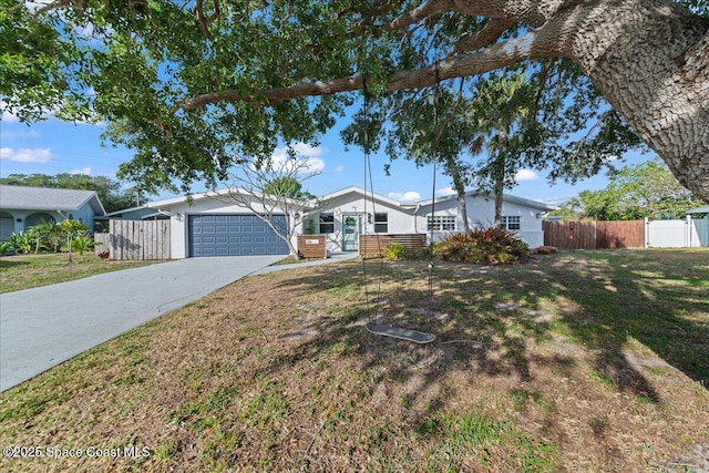 216 Cynthia Ln, Indian Harbour Beach, FL 32937 - single story home featuring driveway, fence, a garage, and a front lawn