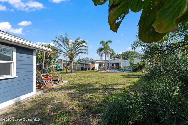 216 Cynthia Ln, Indian Harbour Beach, FL 32937 - view of yard featuring an outdoor pool and a playground
