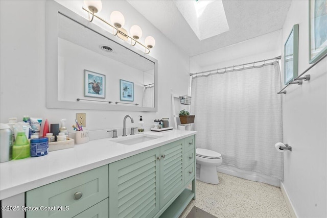 216 Cynthia Ln, Indian Harbour Beach, FL 32937 - bathroom with vanity, toilet, visible vents, speckled floor, and a skylight
