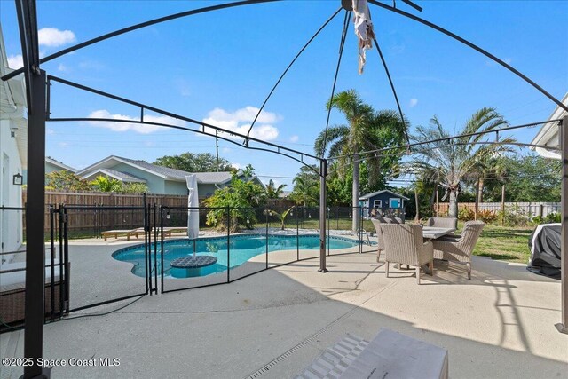 216 Cynthia Ln, Indian Harbour Beach, FL 32937 - view of swimming pool with a patio area, a fenced backyard, outdoor dining space, and a fenced in pool