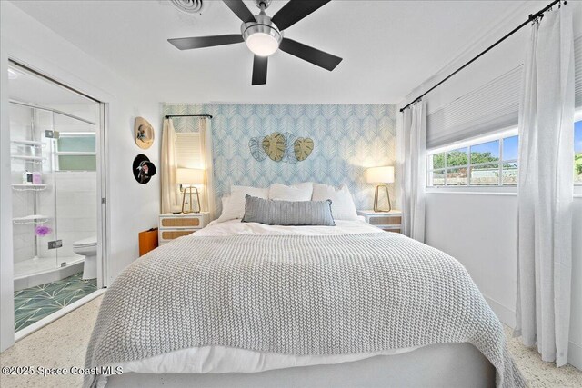216 Cynthia Ln, Indian Harbour Beach, FL 32937 - bedroom featuring baseboards, wallpapered walls, ensuite bath, a ceiling fan, and an accent wall