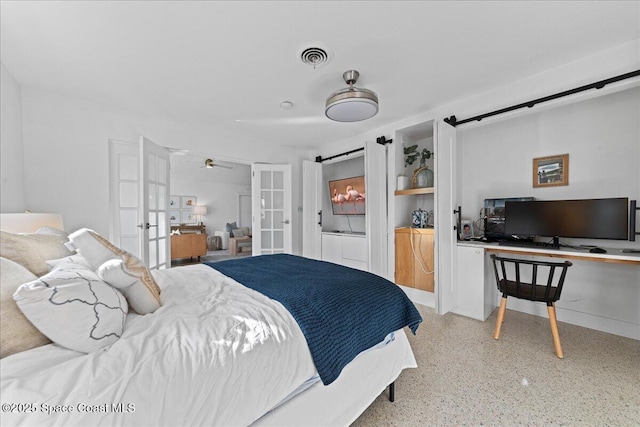216 Cynthia Ln, Indian Harbour Beach, FL 32937 - bedroom featuring a barn door, french doors, light speckled floor, and visible vents