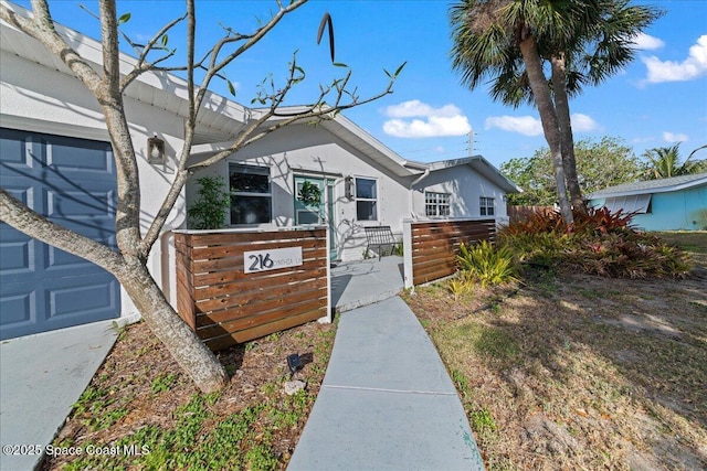 216 Cynthia Ln, Indian Harbour Beach, FL 32937 - view of front of house with stucco siding and fence