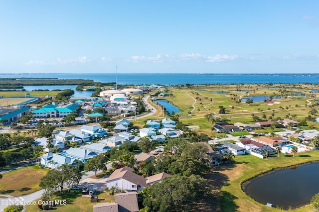 aerial view of residential area featuring a nearby body of water and a golf course