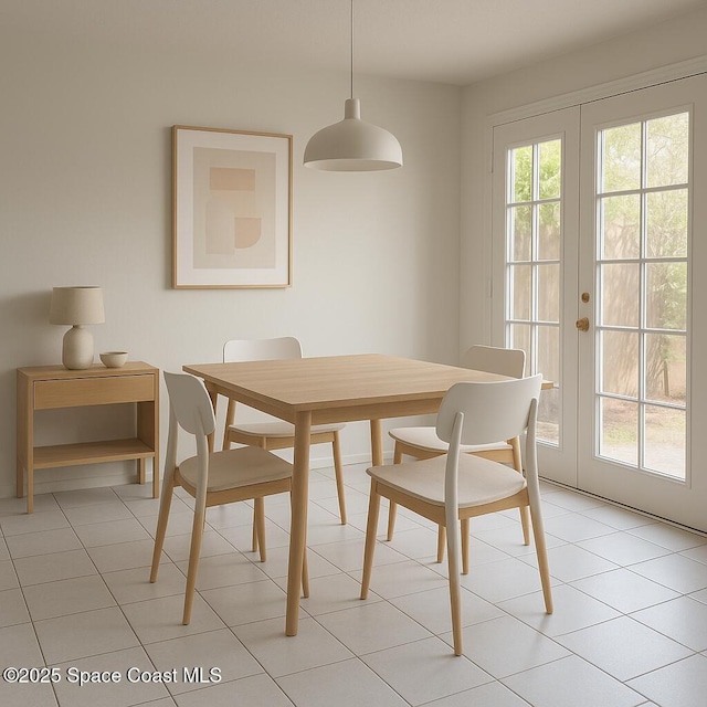 dining area featuring french doors and light tile patterned flooring