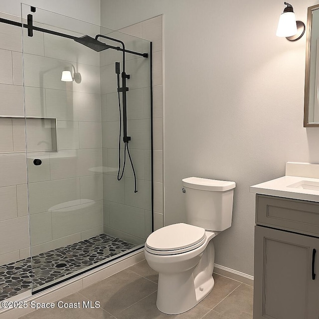 5 Fairway Dr Unit 5, Cocoa Beach, FL 32931 - bathroom featuring tile patterned floors, vanity, and tiled shower