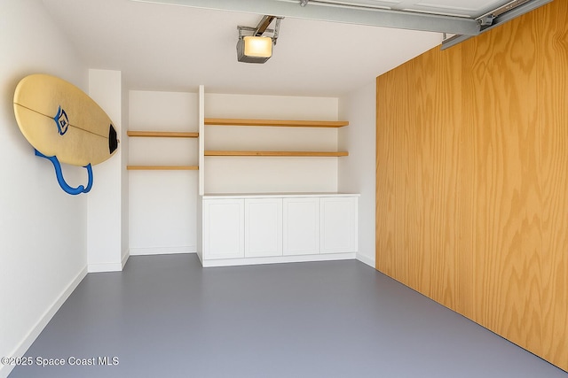 5 Fairway Dr Unit 5, Cocoa Beach, FL 32931 - garage with a garage door opener and baseboards