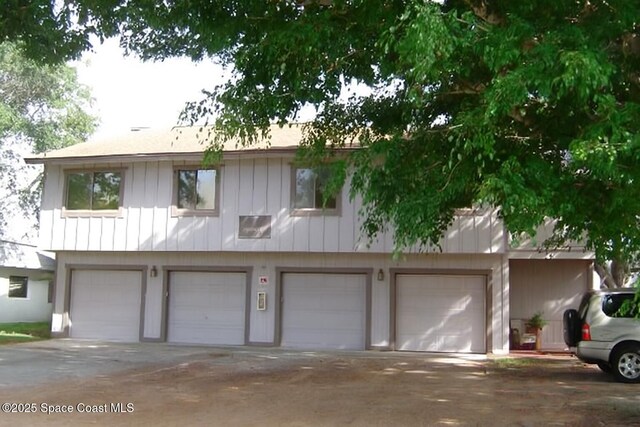 5 Fairway Dr Unit 5, Cocoa Beach, FL 32931 - multi unit property featuring a garage, concrete driveway, and board and batten siding