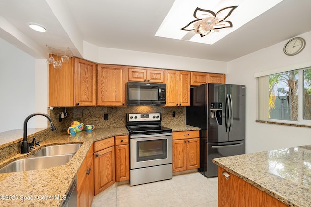 3021 Kirkland Rd NE, Palm Bay, FL 32905 - kitchen featuring brown cabinetry, backsplash, a sink, light stone counters, and black appliances